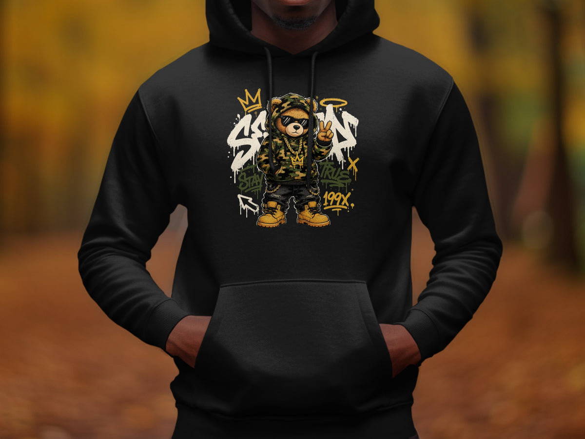 Black hoodie featuring a cartoon teddy bear graphic with camouflage hoodie and gold chains.