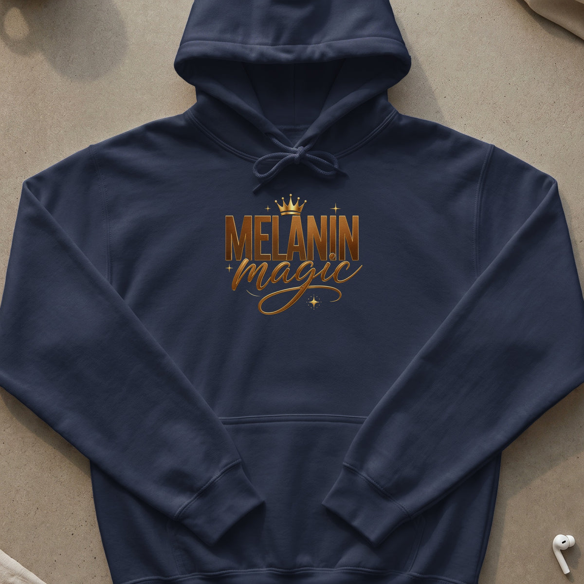 Navy blue hoodie with gold "Melanin Magic" text and crown graphic.