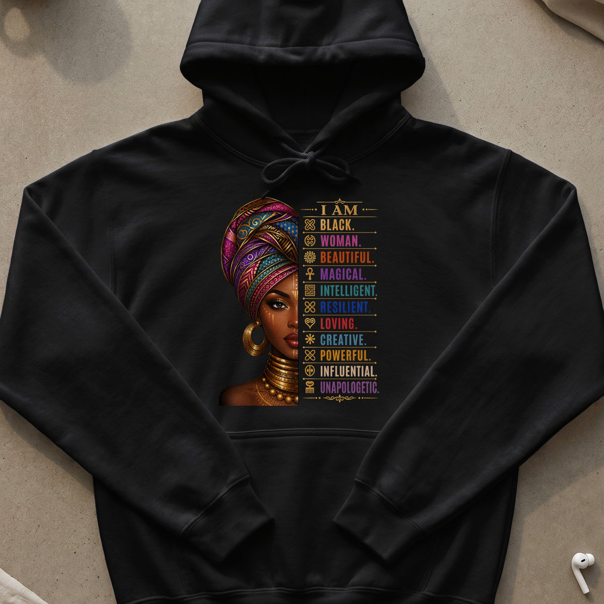 Black hoodie with "I AM BLACK. WOMAN. BEAUTIFUL. MAGICAL. INTELLIGENT. RESILIENT. LOVING. CREATIVE. POWERFUL. INFLUENTIAL. UNAPOLOGETIC." text.