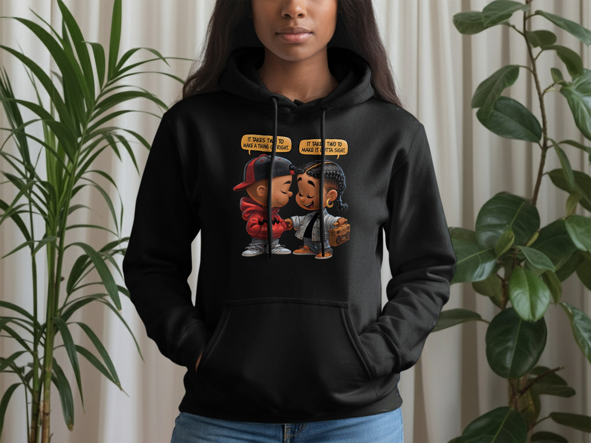 Black hoodie featuring cartoon couple with text bubbles reading "It takes two to make a thing go right."