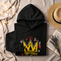 Black hoodie with a yellow crown graphic and red and white abstract marks.