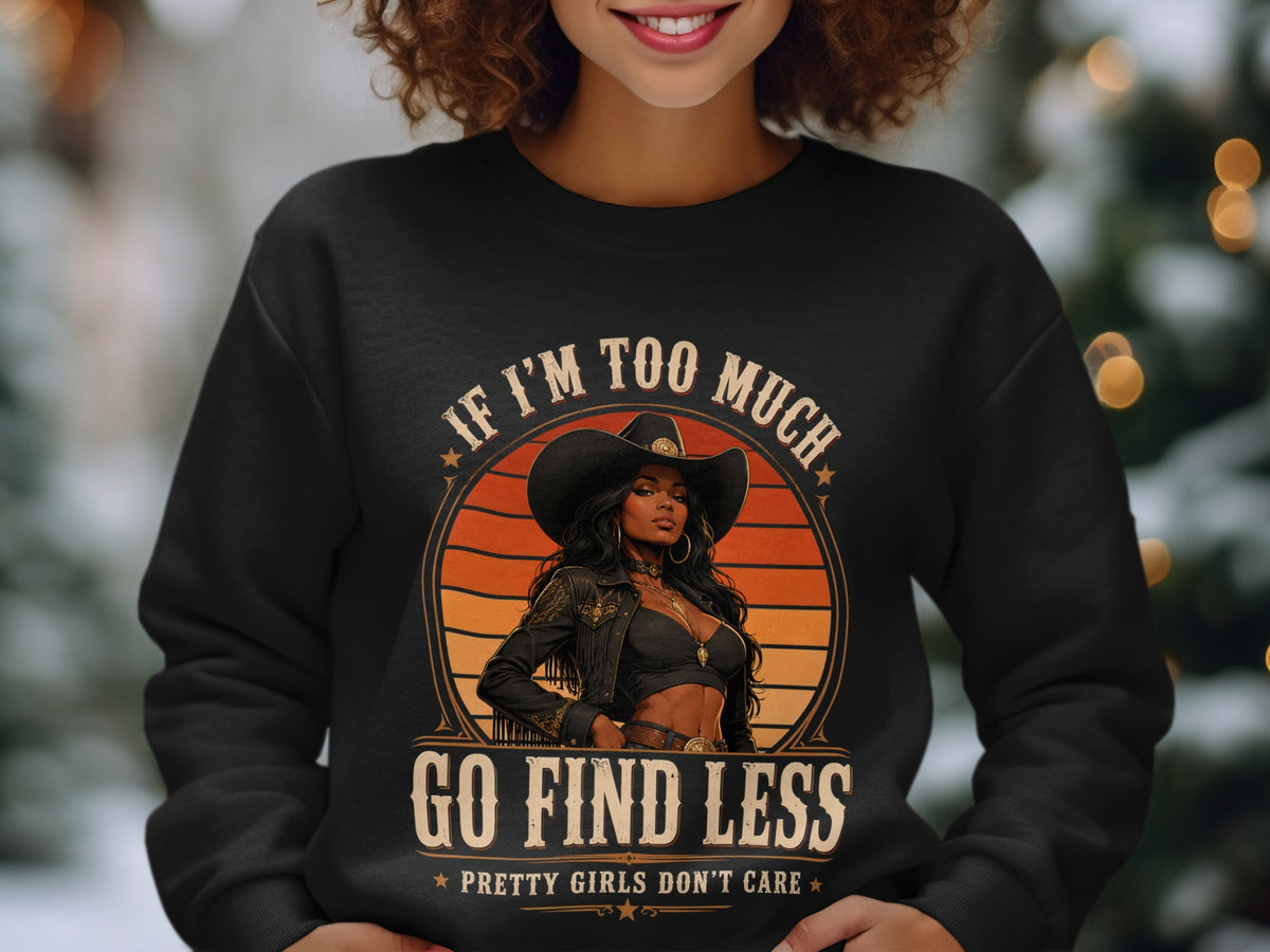Black sweatshirt with graphic of woman in cowboy hat, text "IF I'M TOO MUCH GO FIND LESS".