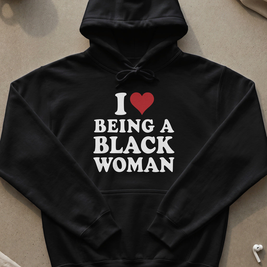 Black hoodie with white text reading "I ❤️ BEING A BLACK WOMAN".
