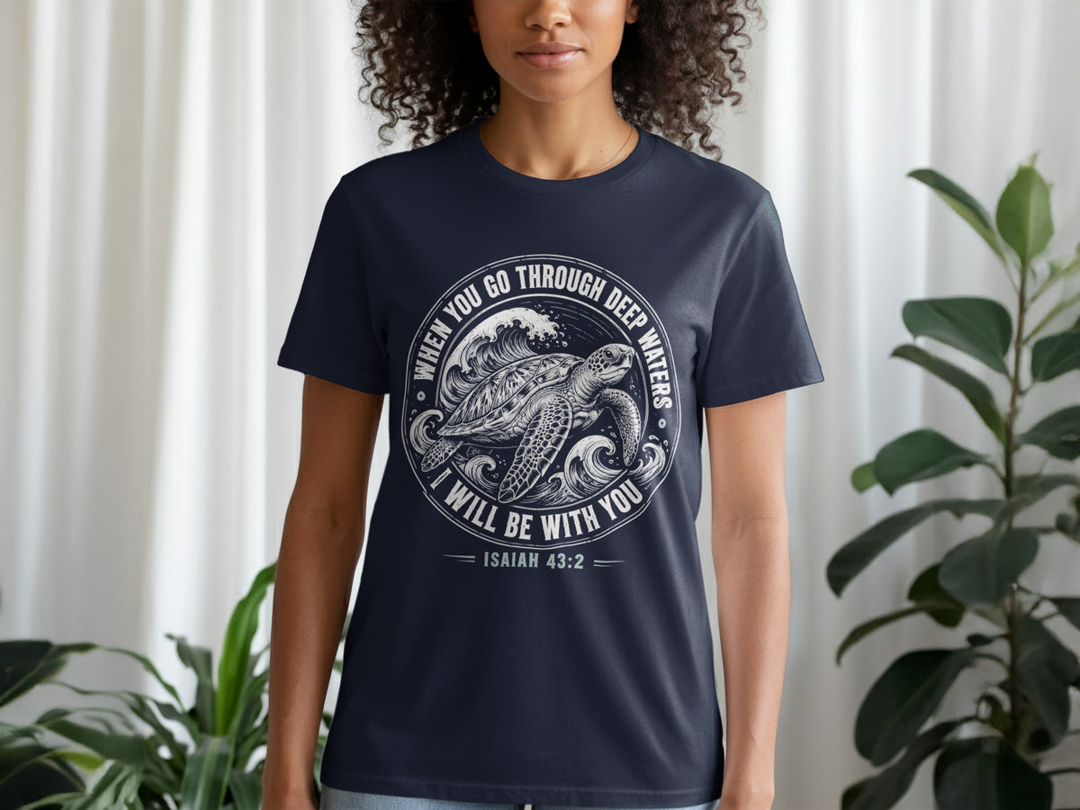 Navy t-shirt with white circular graphic of a sea turtle in waves, text "When You Go Through Deep Waters I Will Be With You Isaiah 43:2".