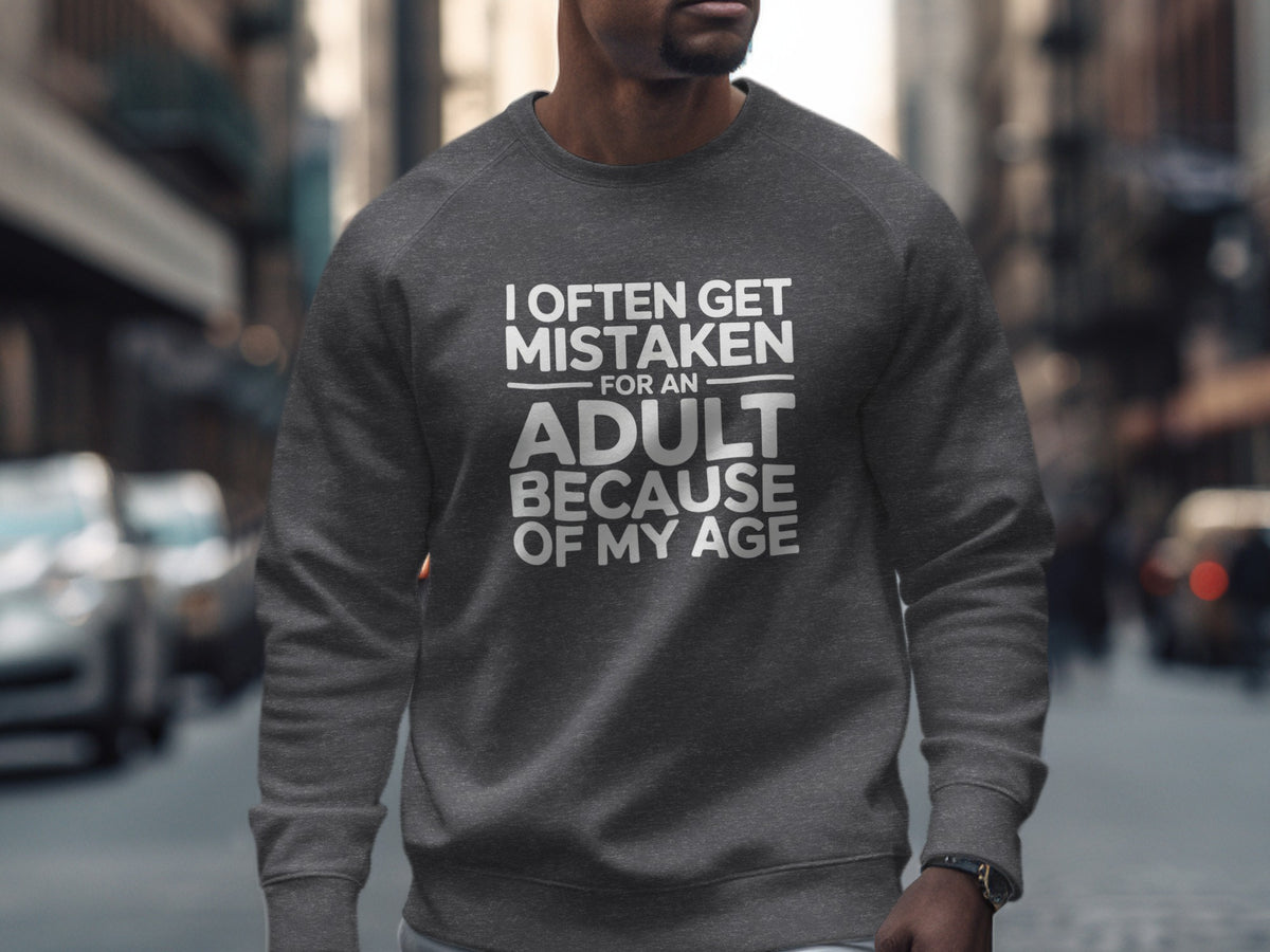 Dark grey sweatshirt with white text that says "I often get mistaken for an adult because of my age."