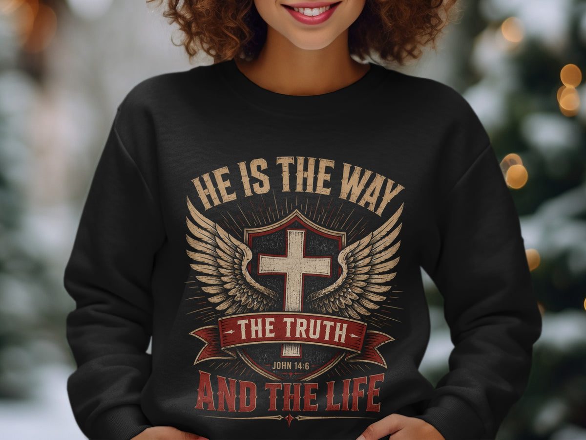 Black sweatshirt with winged cross design and text "He is the way, the truth and the life".