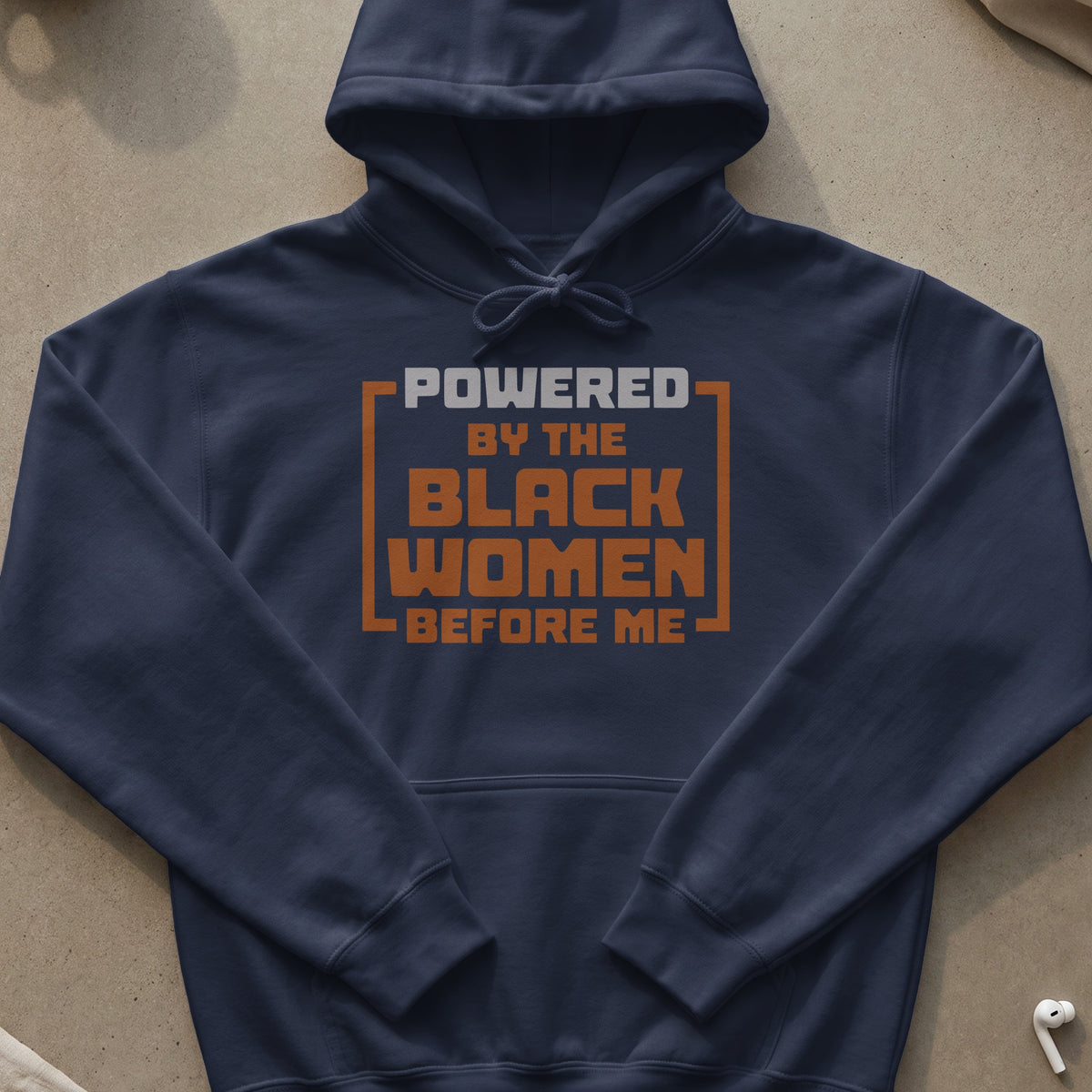 Navy hoodie with text "Powered by the Black women before me".