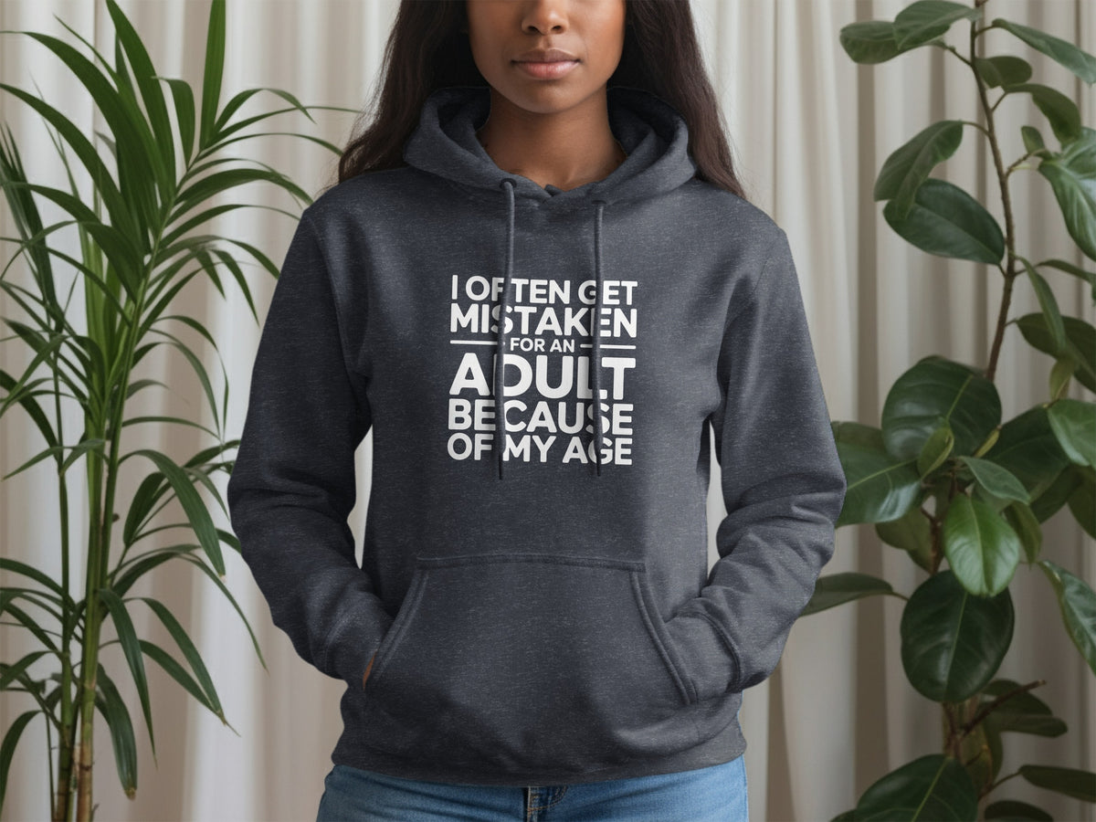 Dark grey hoodie with white text: I often get mistaken for an adult because of my age.