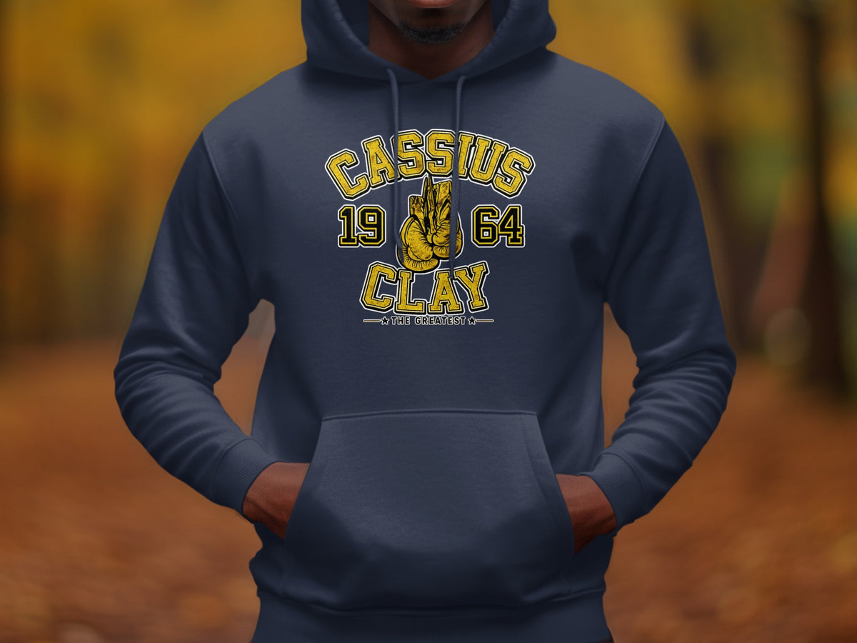 Cassius 1964 Clay graphic hoodie with boxing gloves and "The Greatest" text.