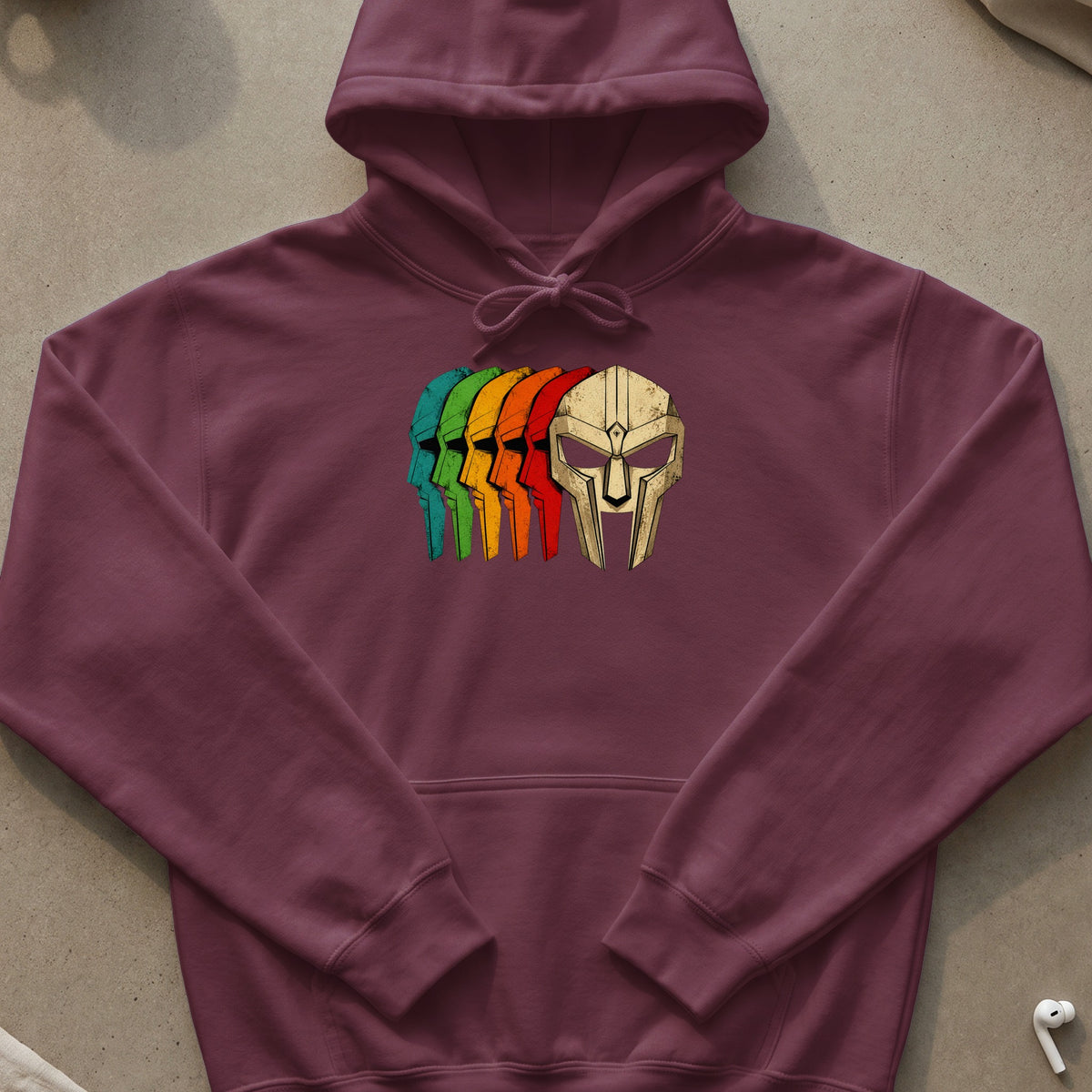 Burgundy hoodie with a graphic of colorful masks and a metallic mask.