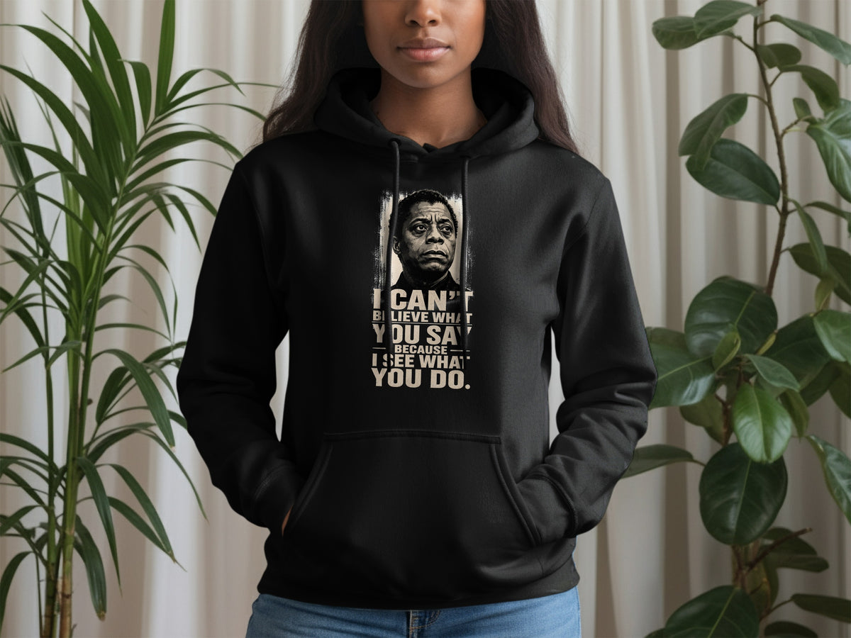 Black hoodie with a portrait of James Baldwin and quote: "I can't believe what you say because I see what you do."