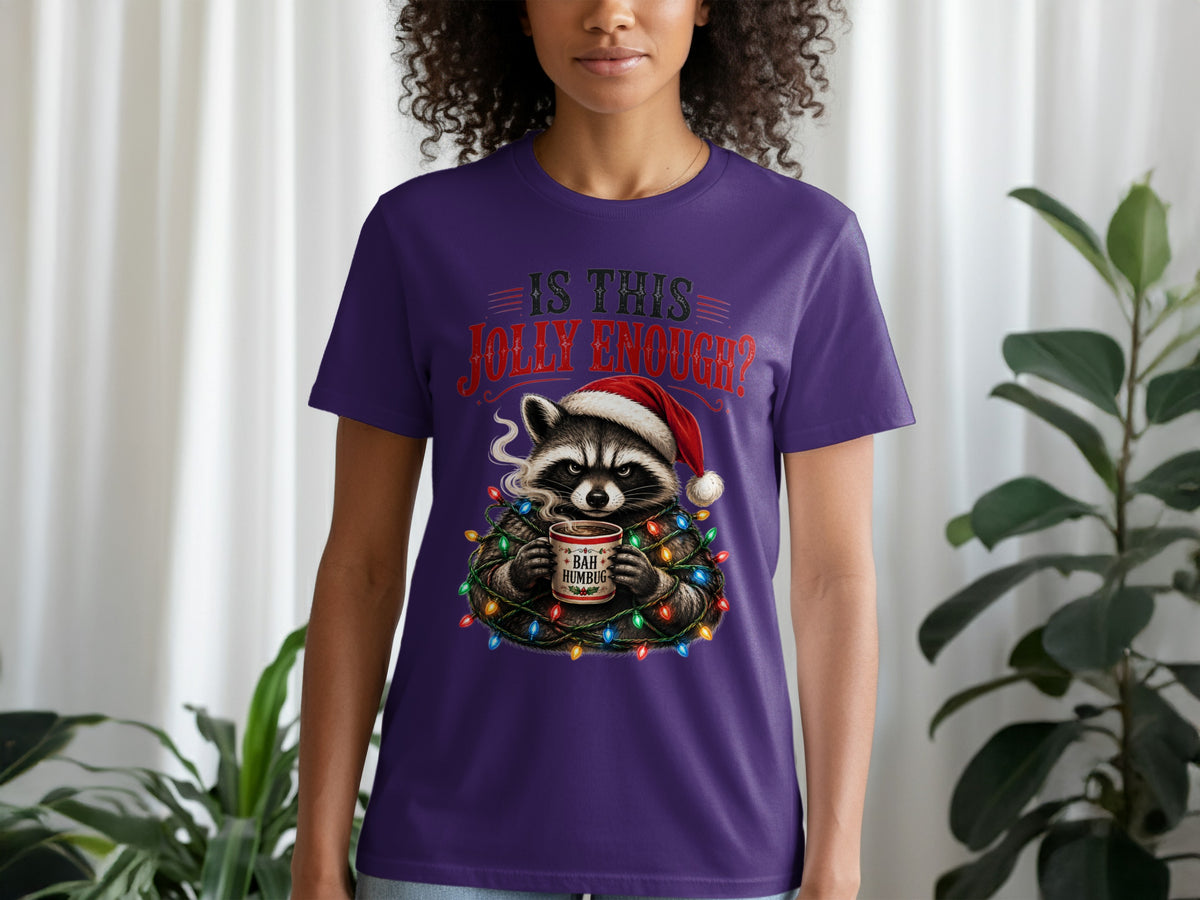 Raccoon in Santa hat holding "Bah Humbug" mug, wrapped in Christmas lights.