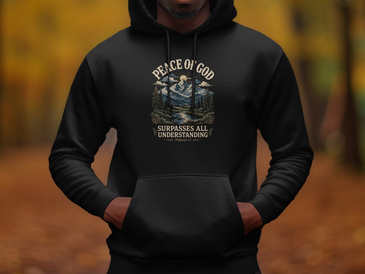 Black hoodie featuring "Peace of God" text with mountain landscape and "Surpasses All Understanding" text.
