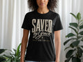 Black t-shirt with "SAVED by Grace EPH. 2:8" text and cross graphic.