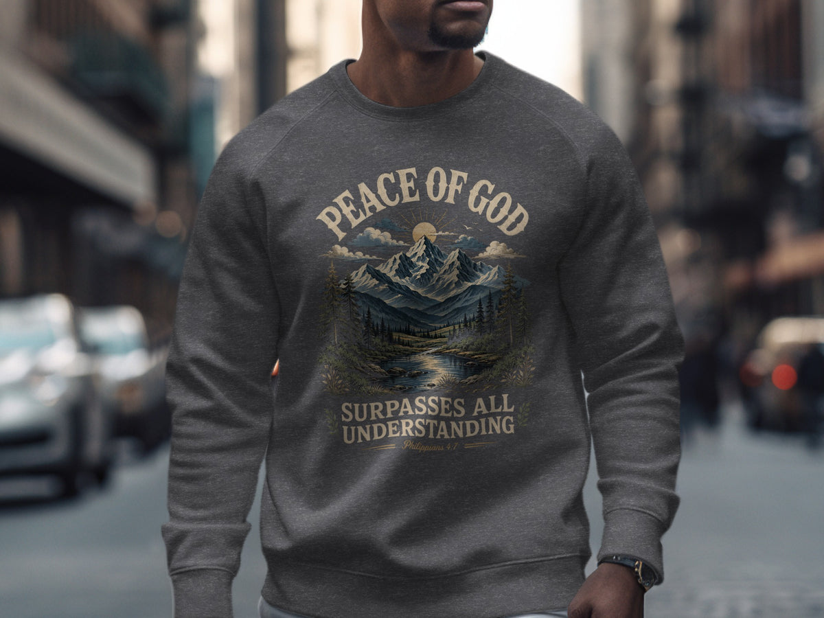 Dark grey crewneck sweatshirt with "Peace of God Surpasses All Understanding" and a mountain landscape.