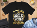Black t-shirt with gold text reading "Powered by the Black Women Before Me."
