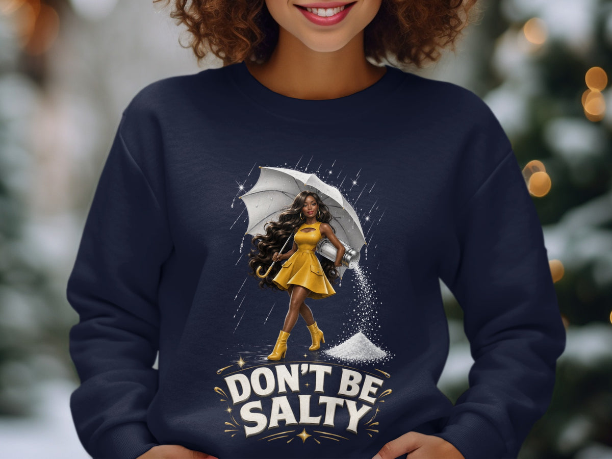 Dark navy sweatshirt with woman holding umbrella and salt shaker, text "DON'T BE SALTY."