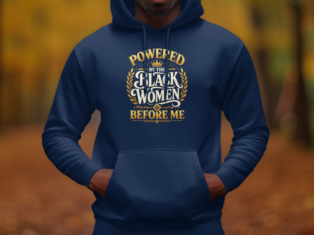 Navy hoodie with gold text reading "Powered by the Black Women Before Me".