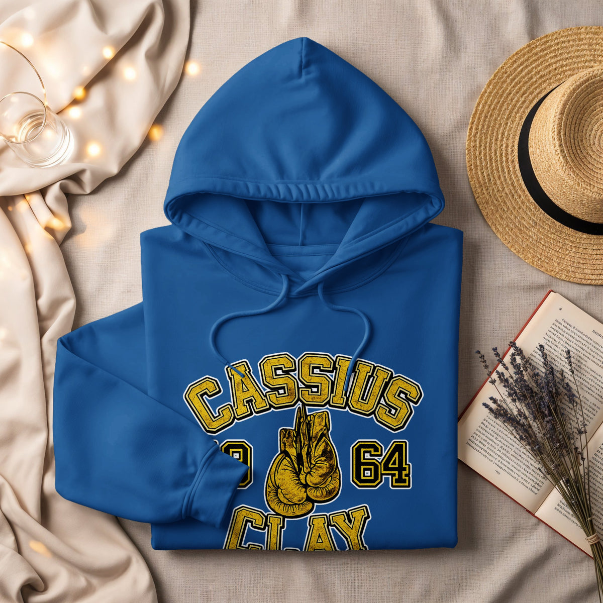 Blue hoodie with "Cassius 1964 Clay" and boxing gloves graphic.